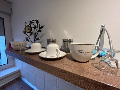 a kitchen counter with two cups and plates on it at Bliss city apartments-Taurunum 1 in Belgrade