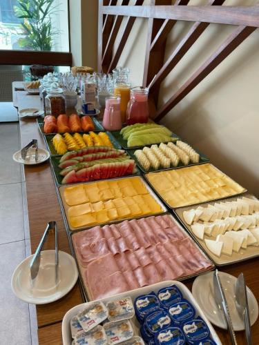 a table topped with lots of different types of food at Makia Flat Muro Alto in Porto De Galinhas