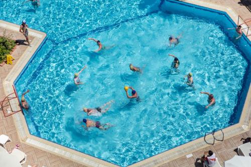 a group of people swimming in a swimming pool at Aydinbey Gold Dreams - Ultra All Inclusive in Avsallar