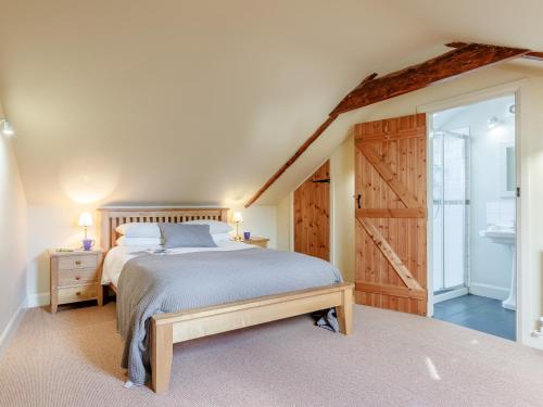 a bedroom with a bed and a sliding barn door at 2 bed property in Axminster BLOLO in Axminster