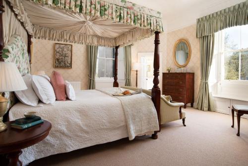 a bedroom with a four poster bed with a canopy at The Tower, Keith Marischal in Humbie