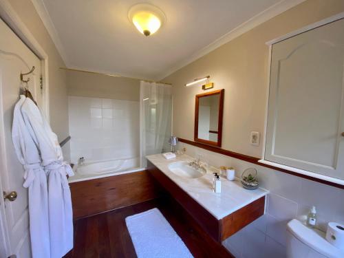 a bathroom with two sinks and a bath tub at Acorn House in Cape Town