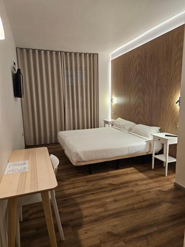 a hotel room with a bed and two tables at Hotel Villasegura in Molina de Segura