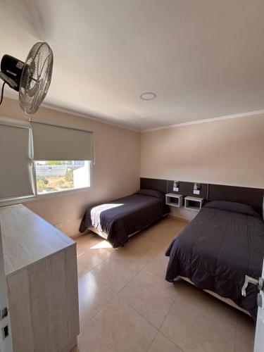 En eller flere senge i et værelse på Complejo ALI121 Las Grutas