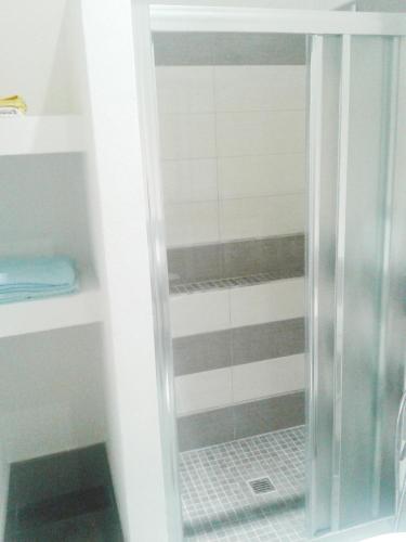 a shower with a glass door in a bathroom at Lisetta Rooms in Vernazza