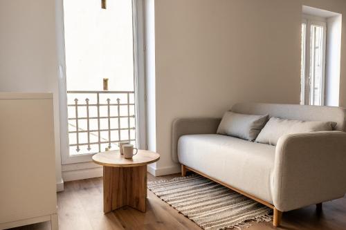 a living room with a couch and a table at T2 Le Miredames in Castres