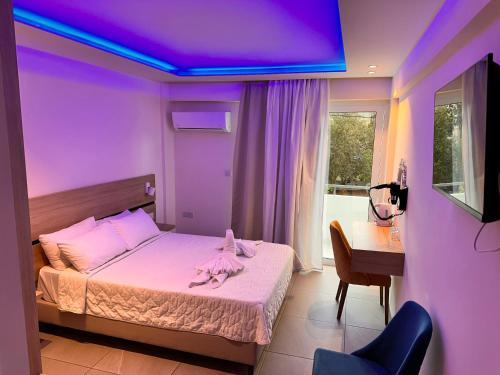 a bedroom with a bed with a purple ceiling at San Remo Hotel in Larnaka
