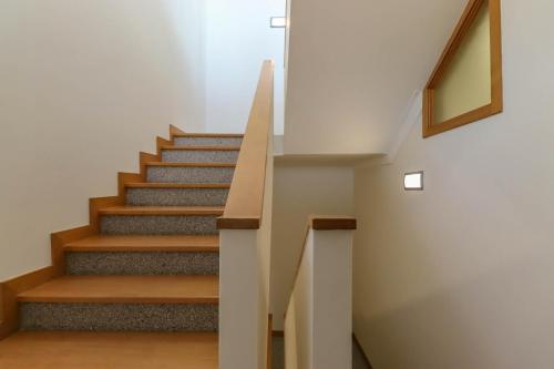 a staircase in a house with wooden steps at The Ocean View Villa in Viana do Castelo