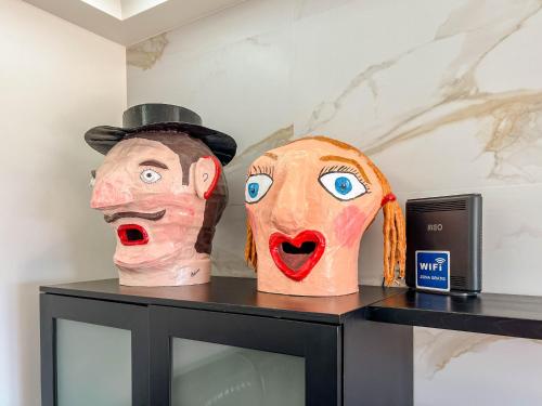 two masks sitting on top of a table at The Ocean View Villa in Viana do Castelo