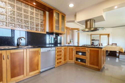 a kitchen with wooden cabinets and a sink at The Ocean View Villa in Viana do Castelo