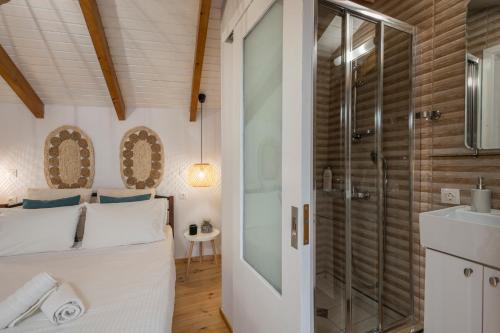 een slaapkamer met een douche en een bed met een glazen deur bij Mariviky design apartment in Chania
