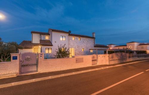 a house with a fence on the side of a road at Villa Lory in Vabriga