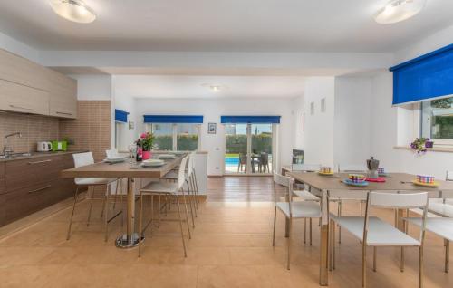 a kitchen and dining room with tables and chairs at Villa Lory in Vabriga