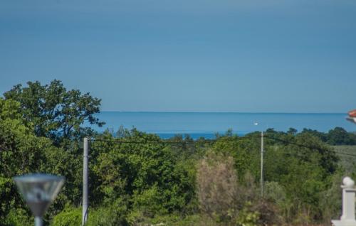 a view of the ocean from behind a fence at Villa Lory in Vabriga