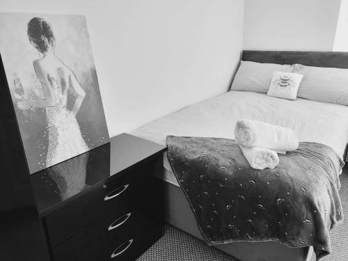 a child laying on a bed next to a dresser at High Street, 2 bed, newly refurb in Leamington Spa