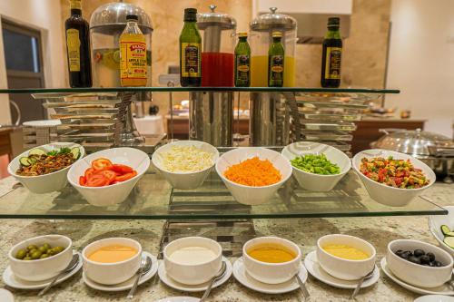 a buffet with bowls of food on a counter at JOHNWOOD HOTEL by Bolton in Wuse