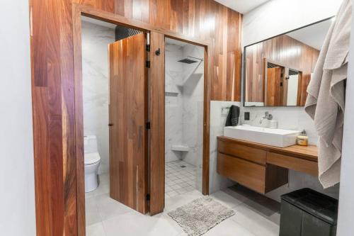 a bathroom with a sink and a toilet at Contemporary 4 bd house near Metropolitano park in Guadalajara
