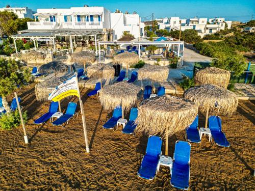 a group of chairs and umbrellas on a beach at Theologos Beach in Antiparos Town