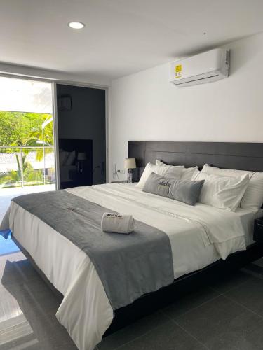 a large white bed in a bedroom with a window at Malokas Resort - Socorro - San Gil in Socorro