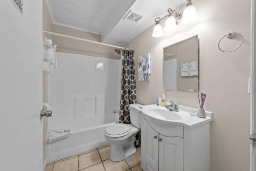 a bathroom with a sink and a toilet and a bath tub at Comfy 1BR By the Beach with Pool and Parking 12 in Myrtle Beach