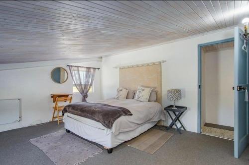 a bedroom with a bed in a white room at Littlevlei Selfcatering in Wellington