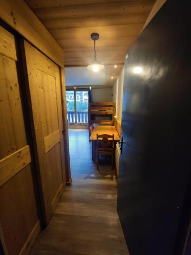 a hallway leading to a room with a table in a house at ski-in ski-out 05 in Val Thorens