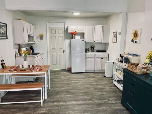 a kitchen with white cabinets and a white refrigerator at Cozy 1BR with Patio in the Heart of Albany in Albany