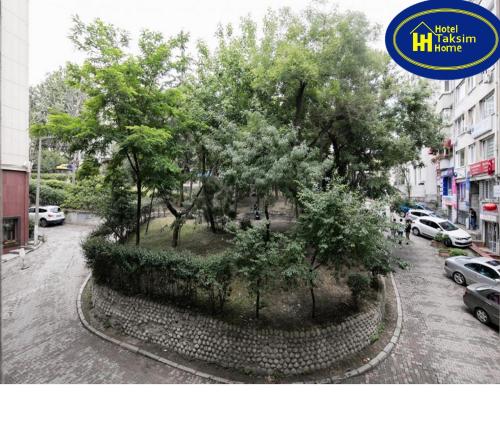 a tree in the middle of a street with cars at Hotel Taksim Home in Istanbul