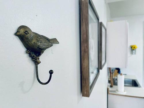 a figurine of a bird hanging on a wall at Cozy 1BR with Patio in the Heart of Albany in Albany