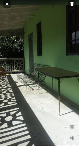 a table and benches sitting outside of a building at The Hillside Hideaway in Micoud
