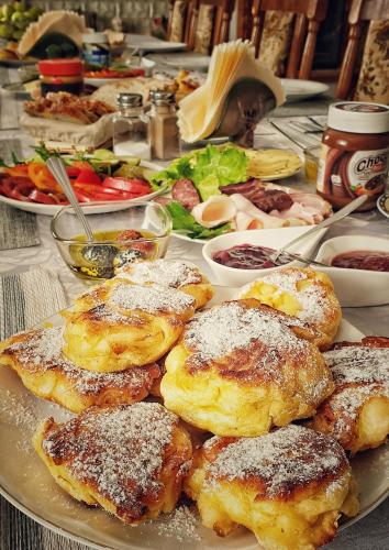 a plate of food on a table with food at Agroturystyka Nowy Kraków in Jeżyce