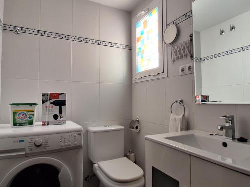 a white bathroom with a toilet and a sink at The 2 bed-Roof terrace-apartment in Málaga