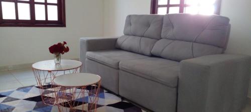 a living room with a couch and a table at Casa Temporada in Natal