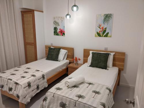 two beds in a room with two beds sidx sidx sidx at Seaview serenity apartment in Flic-en-Flac