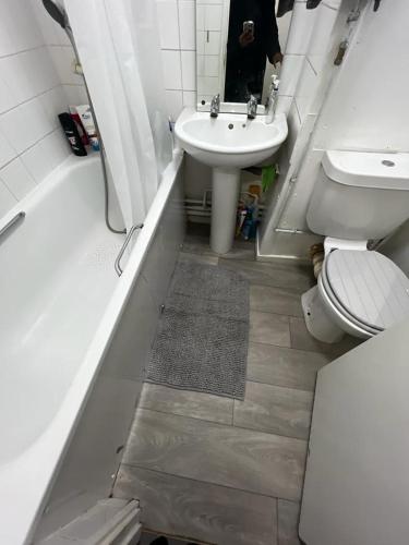a bathroom with a toilet and a sink at Holloway Ap in London