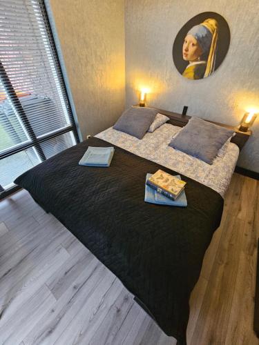 a bedroom with two beds and a painting on the wall at City Stay Juliette in Enschede
