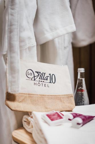 a hotel bag sitting on top of a table at La villa 10 HÔTEL SPA in Étretat