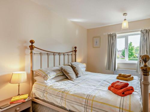 a bedroom with a bed with two towels on it at 3 Bed in Sheringham 43467 in Sheringham