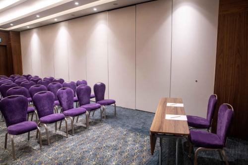 a conference room with purple chairs and a table at Uranus Istanbul Topkapi in Istanbul