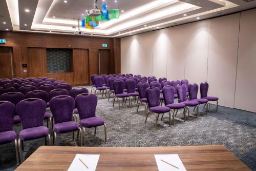 a conference room with purple chairs and a podium at Uranus Istanbul Topkapi in Istanbul