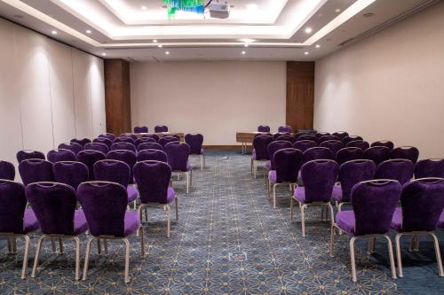 an empty room with purple chairs and a screen at Uranus Istanbul Topkapi in Istanbul