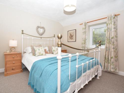 a bedroom with a white bed and a window at 1 bed in Brampton 56564 in Irthington