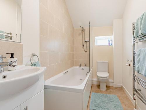 a white bathroom with a sink and a toilet at 3 Bed in Langtree 58822 in Langtree