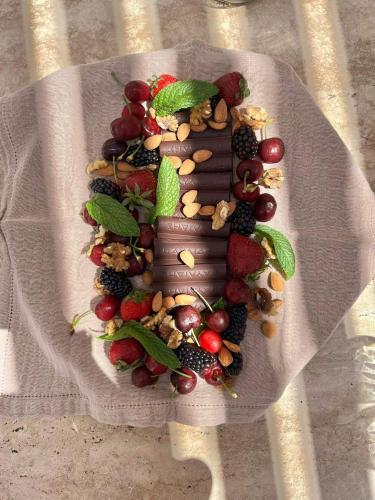 a plate of fruits and vegetables on a table at Ethos Retreat Imerovigli, Santorini in Imerovigli