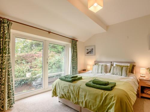 a bedroom with a bed and a large window at 2 Bed in Coleford 60103 in Coleford