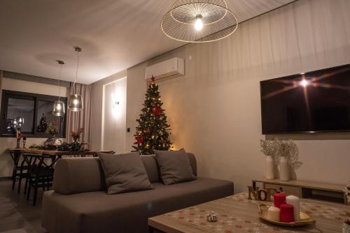 a living room with a christmas tree and a couch at Sezian Boutique Homes and Villas in Preveza