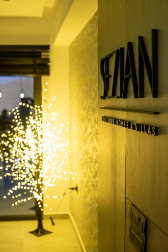 a person standing in a room with a sign on the wall at Sezian Boutique Homes and Villas in Preveza