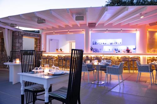 a restaurant with tables and chairs on a patio at DeLight Boutique Hotel - Small Luxury Hotels of the World in Agios Ioannis Mykonos