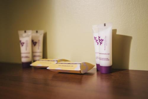 two bottles oficating products sitting on a wooden table at Hotel Jurmala Spa in Jūrmala