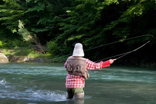a person in the water holding onto a string in a river at Bed & Breakfast Dvorec in Petrovče